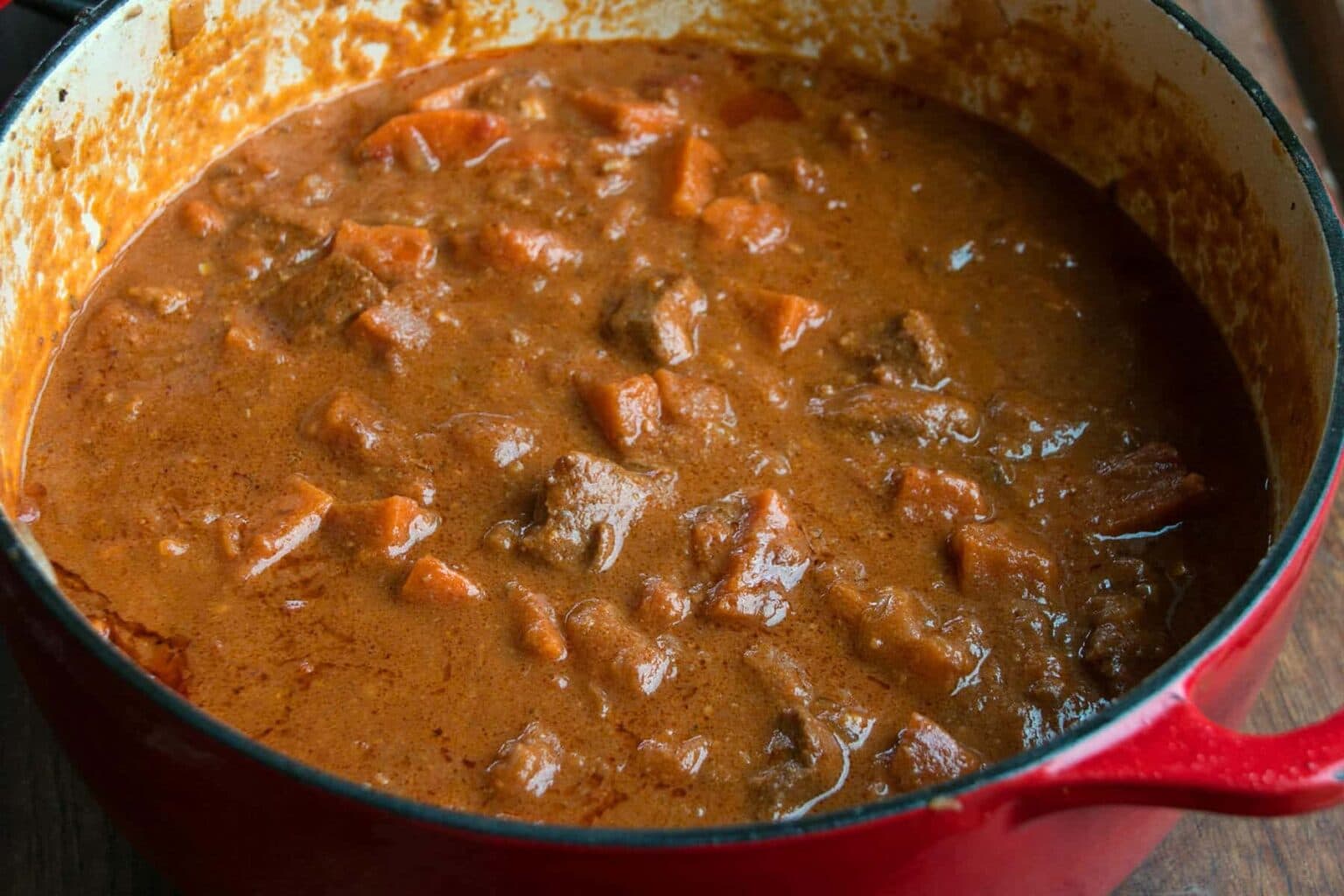 Domada Gambian peanut stew with chicken and sweet potato in a pot, Gambia's national dish