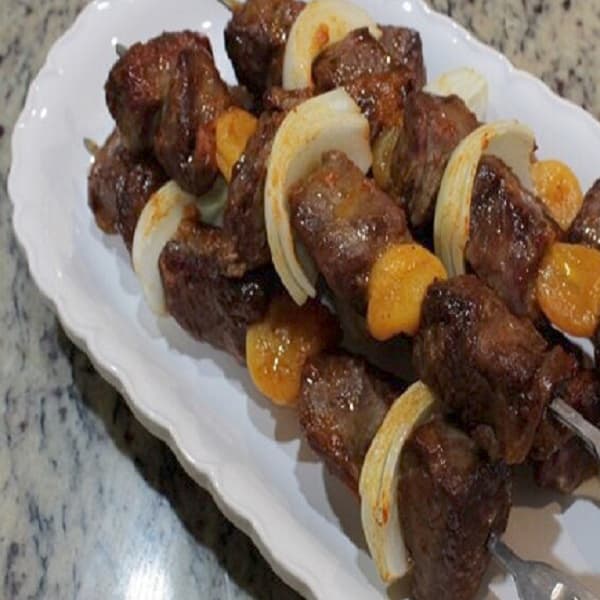 South African Lamb Sosaties on a braai grill, spiced lamb and apricot skewers marinated in Cape Malay curry and tamarind