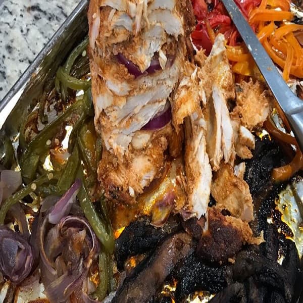 Homemade Chicken Shawarma wrapped in flatbread with garlic sauce and vegetables, North African style spiced chicken