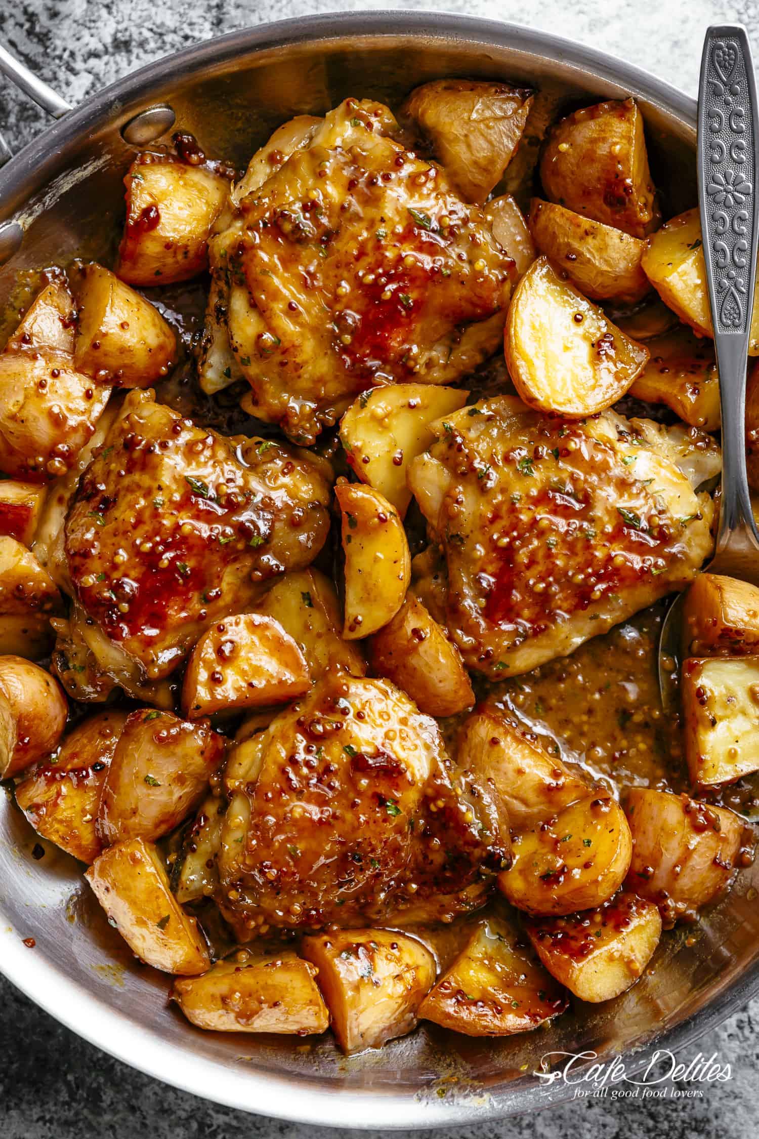 South African Mustard Chicken and Potatoes baked golden in a roasting dish with a tangy mustard marinade