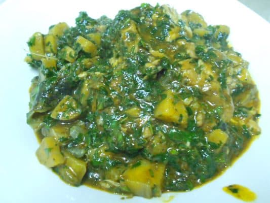 Nigerian Plantain Porridge with unripe plantain, palm oil, and spinach in a pot, a West African one-pot meal