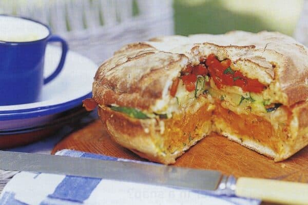 South African Picnic Bread sliced to reveal cheese, bacon, and spring onion filling, a popular braai bread from South Africa