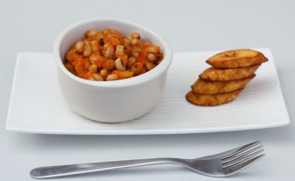 Ghanaian Red Red stew served with fried ripe plantain, a traditional black-eyed bean dish from Ghana