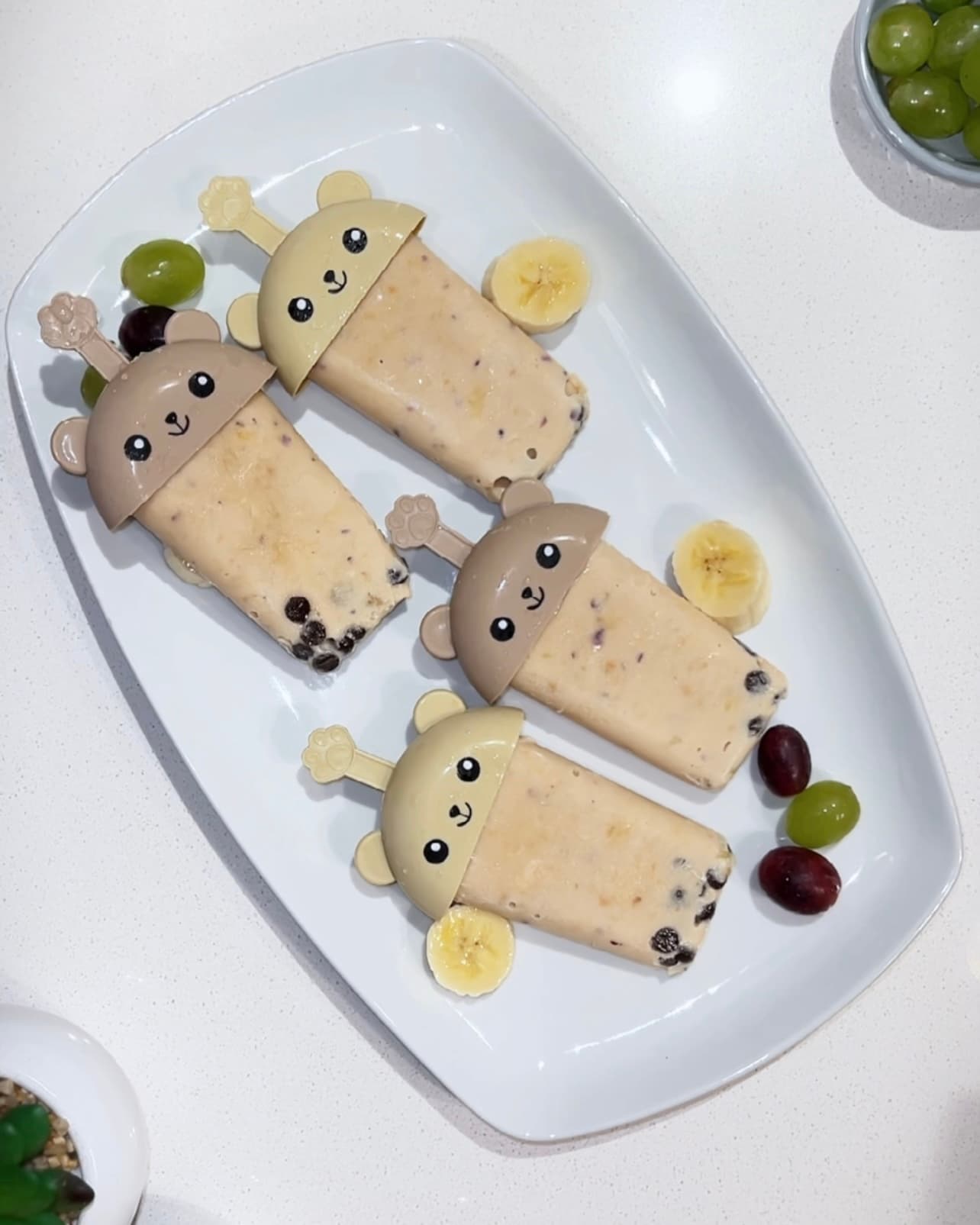 South African Creamy Yogurt Popsicles with fresh fruit on a plate, a healthy refreshing frozen dessert