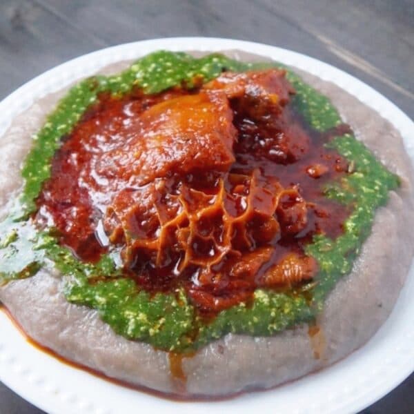 Ewedu soup in a bowl with amala and gbegiri, a traditional Yoruba jute mallow soup from southwestern Nigeria
