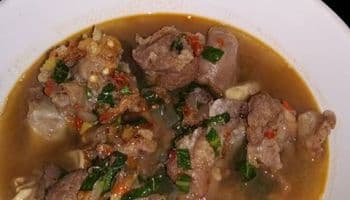 Nigerian Potato Pepper Soup in a bowl with fish and mushrooms, a spiced West African soup flavoured with traditional pepper soup spices