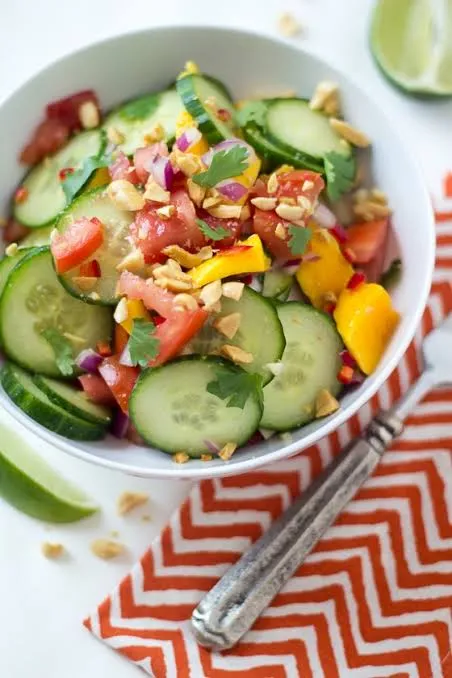 African mango and cucumber salad with tomato, chilli, coriander and roasted peanuts