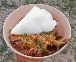 Agidi, also called eko, a Nigerian set corn starch block wrapped in leaves and served with akara