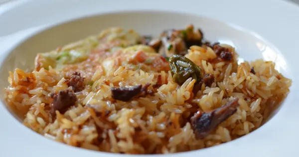 Angwa moo, a Ghanaian oiled rice dish fried with browned onions and salted beef