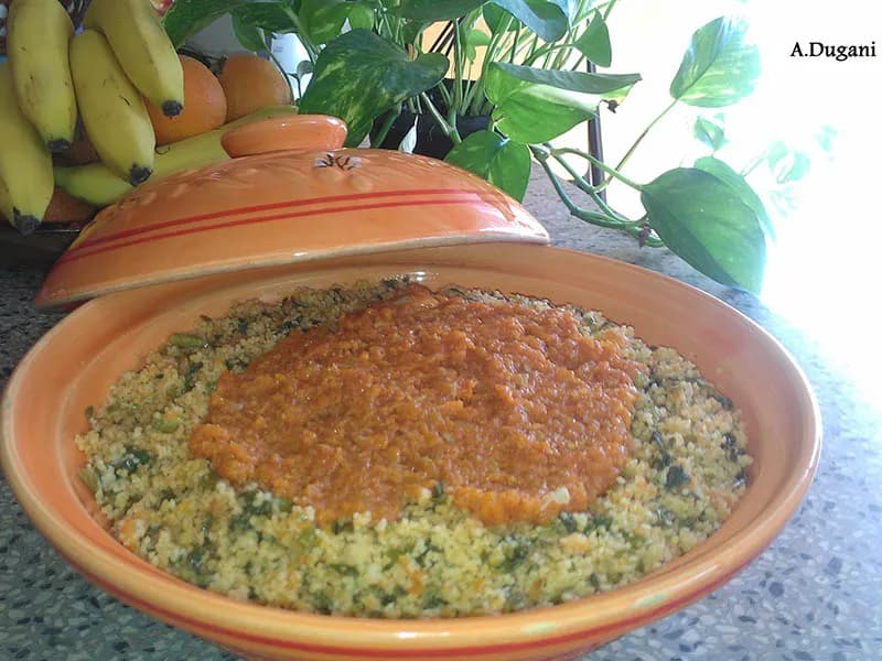 Aslooz, a Libyan steamed couscous dish with asparagus, dill and a spiced tomato sauce