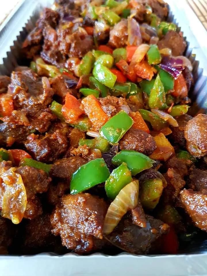 Asun, Nigerian smoked goat meat tossed with habanero, onions and bell peppers