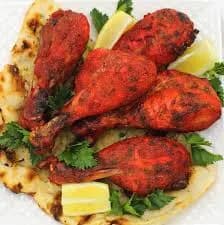 Tandoori chicken legs marinated in yoghurt and spices, roasted until charred