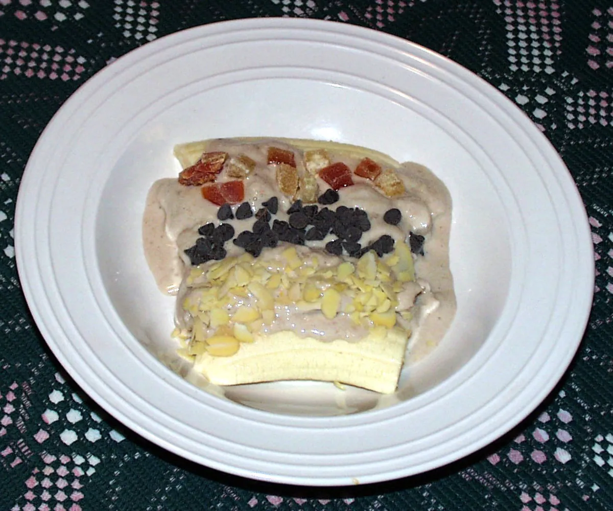 Banana glace, a Senegalese dessert of frozen banana cream over fresh banana with nuts and candied fruit