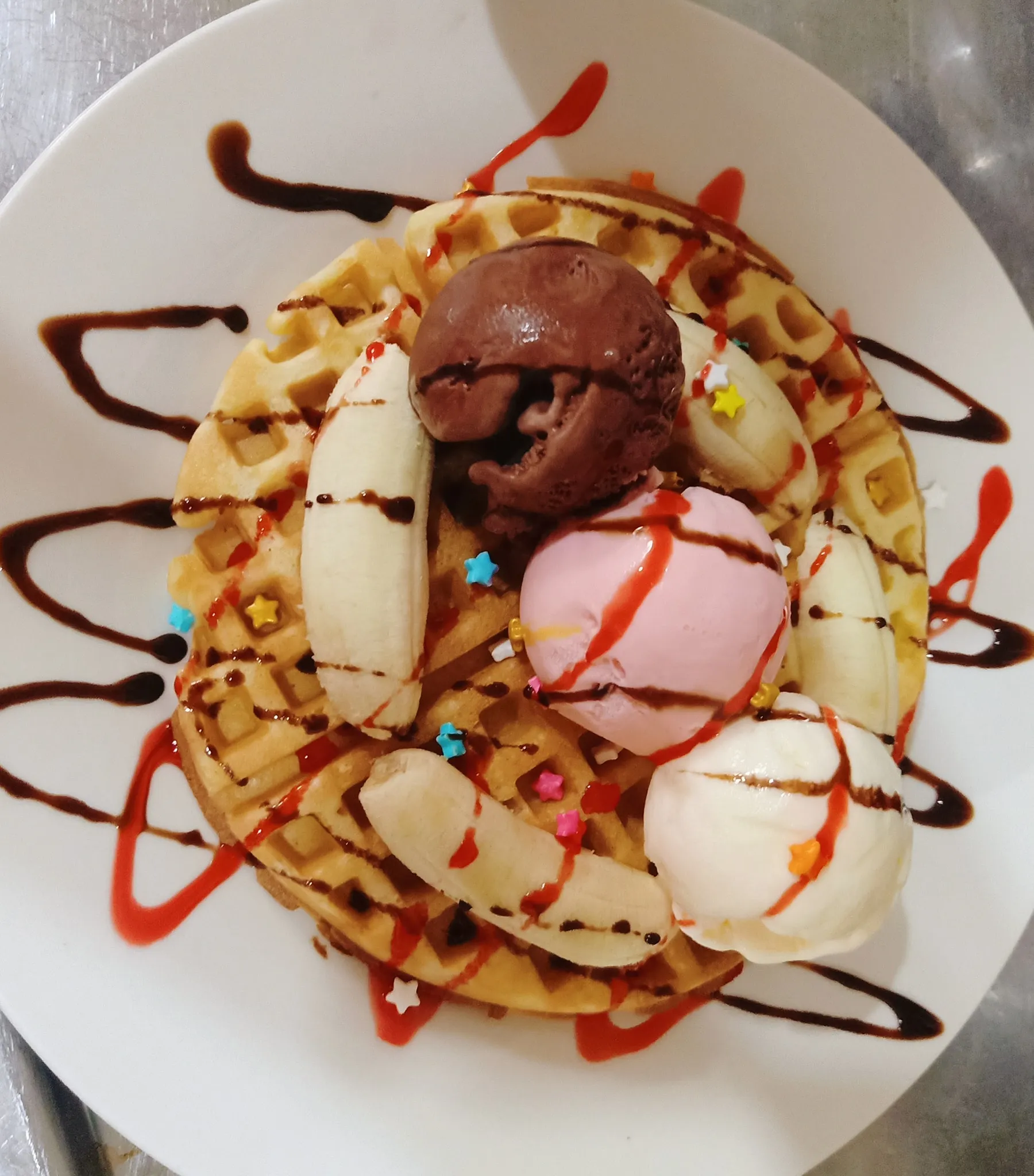 Banana waffles served warm with sliced banana and syrup