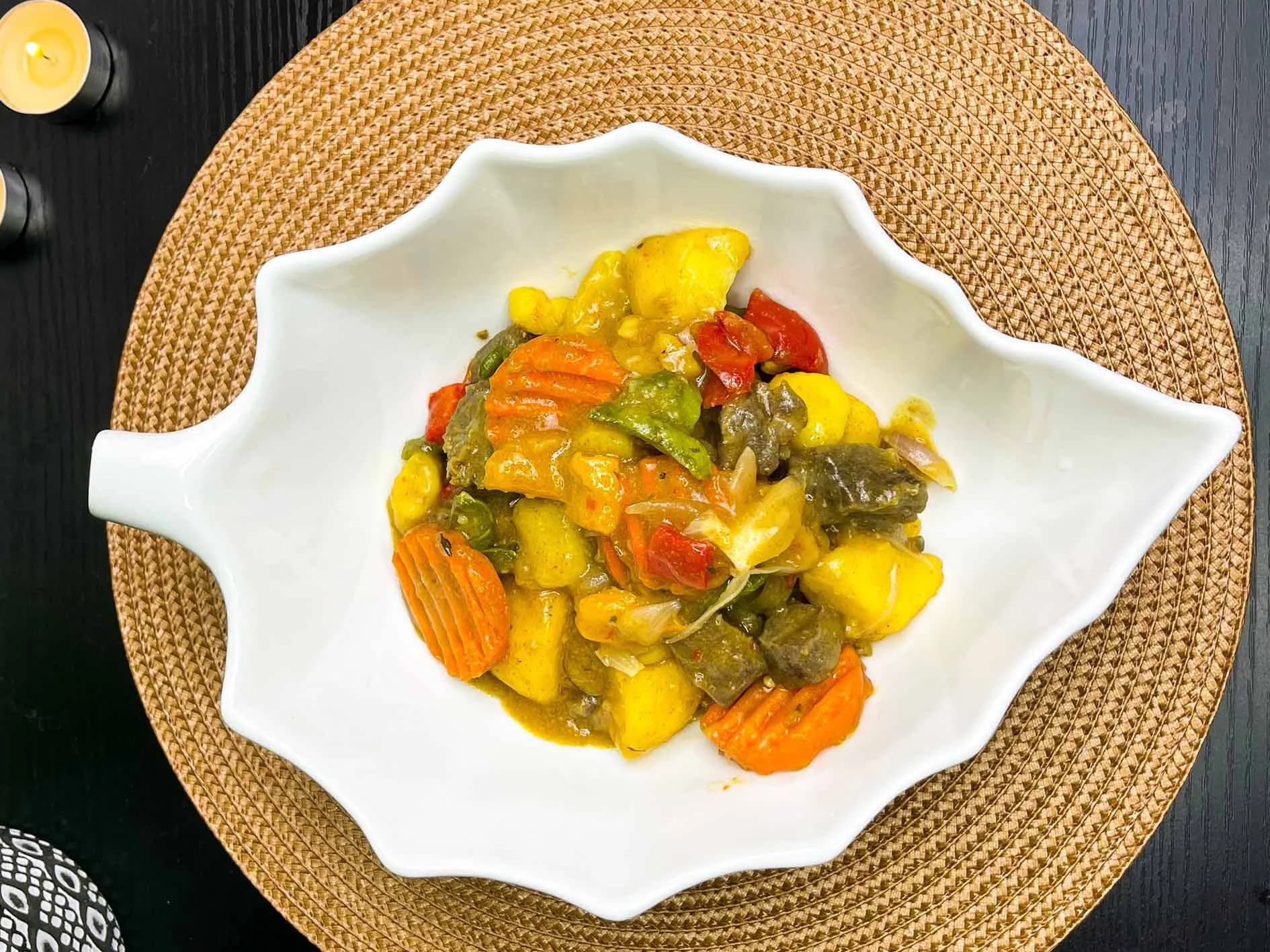 Beef and potatoes sauce with bell peppers, carrots and coriander
