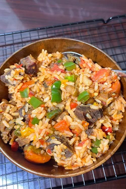 Beef stir fry rice and beans in a Nigerian pepper base with bell peppers