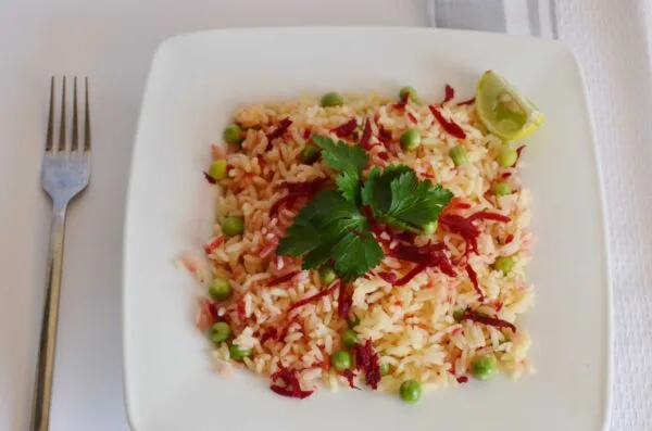 Beetroot rice, deep purple rice cooked with beetroot and green peas, garnished with parsley