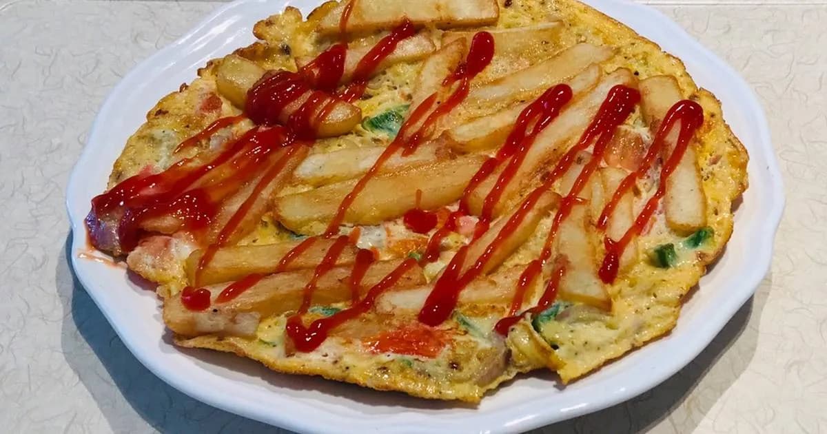 Chips mayai, Tanzanian chips cooked into an omelette, served with kachumbari
