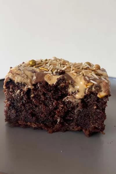 A layered chocolate cake with caramel cream icing