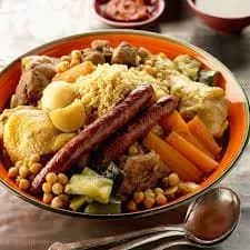 Couscous royale, couscous piled with grilled lamb, chicken, merguez and a chickpea stew