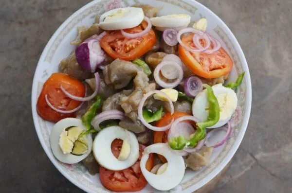 Danwake, Northern Nigerian bean and baobab leaf dumplings tossed with oil, pepper and fresh vegetables
