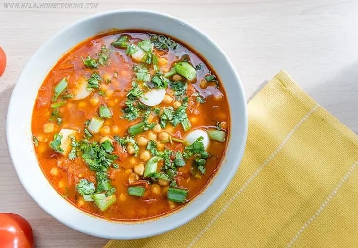 Dobara, an Algerian chickpea soup from Biskra topped with fresh tomato, coriander and pickled peppers