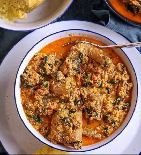 Egusi soup, a Nigerian melon seed soup with meat, fish and pumpkin leaves, served with pounded yam