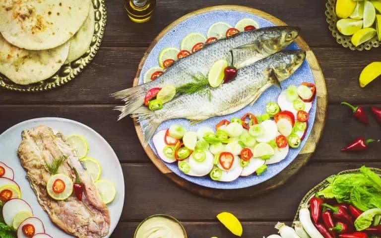 Feseekh, Egyptian salted fermented mullet, served with bread and green onions
