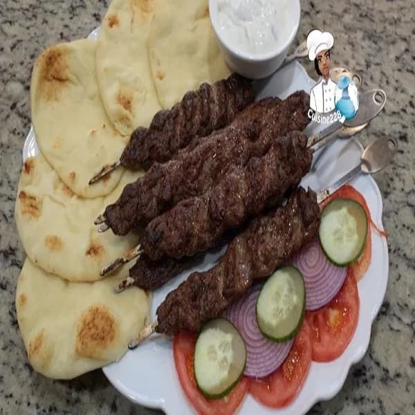 Egyptian kofta, seasoned minced lamb moulded onto skewers and grilled
