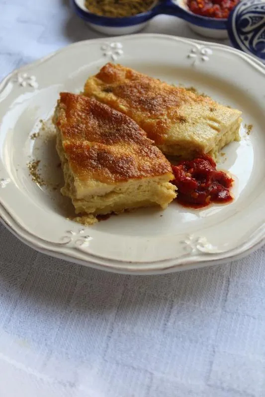 Garantita, an Algerian baked chickpea flour flan served hot in a baguette with cumin and harissa
