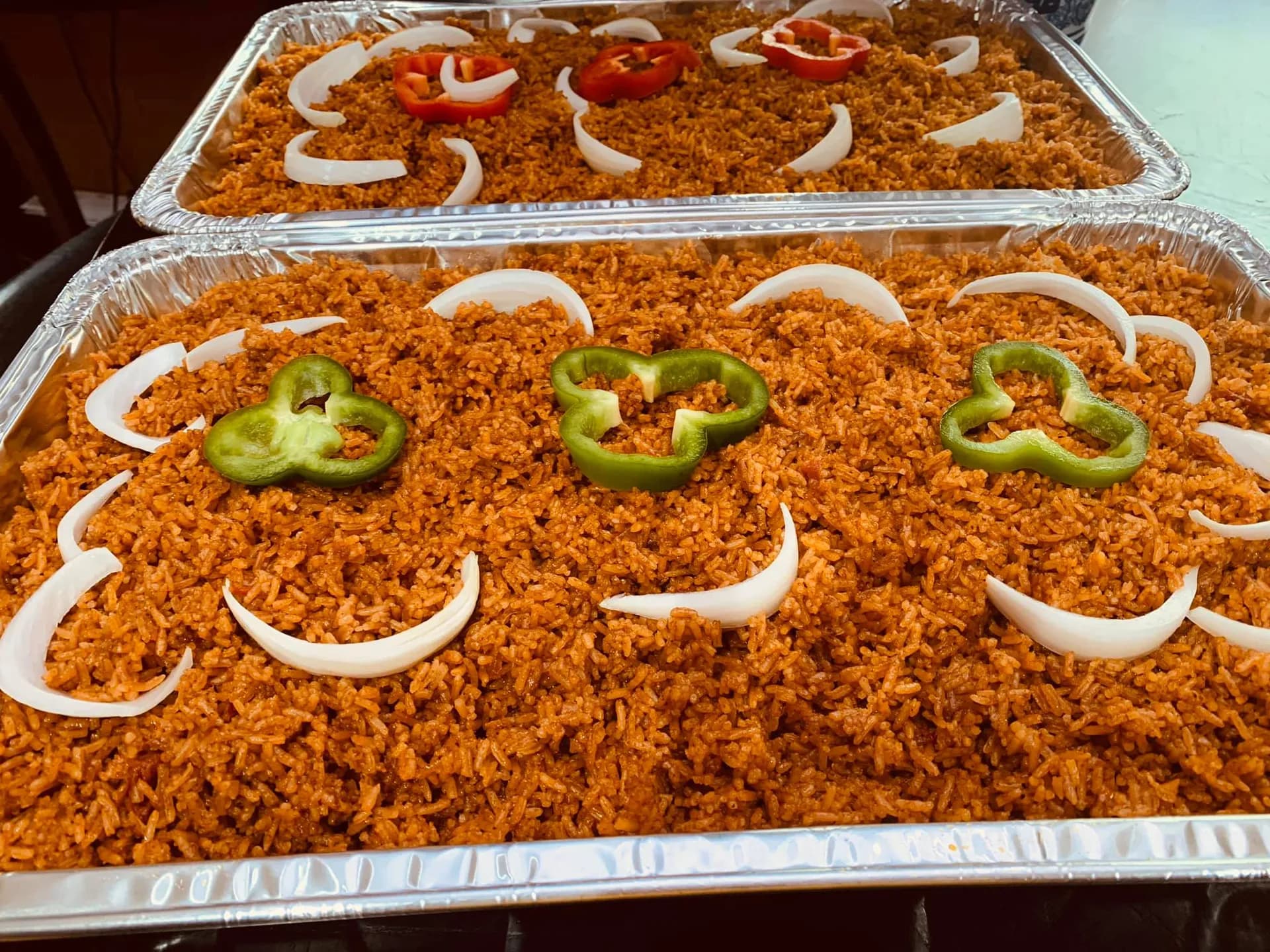 Ghana jollof rice, a tomato based basmati rice dish with mixed vegetables, served with chicken