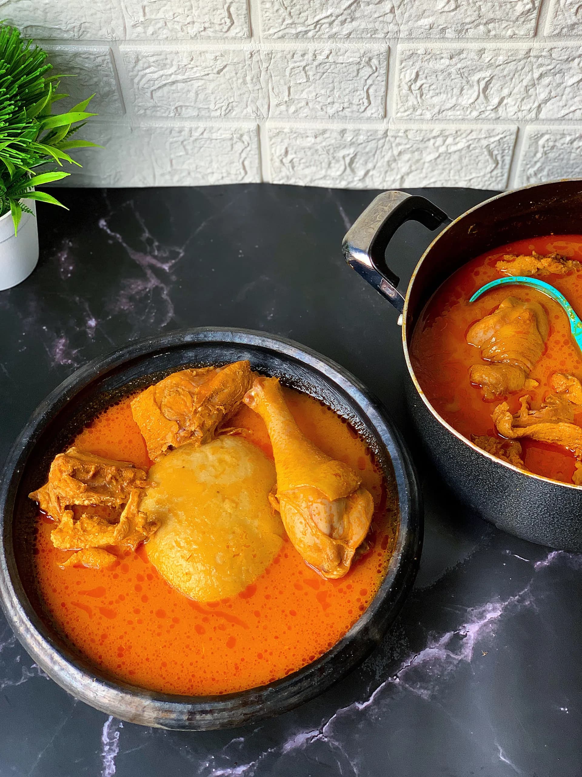 Ghanaian chicken light soup, a clear tomato and habanero broth served with fufu