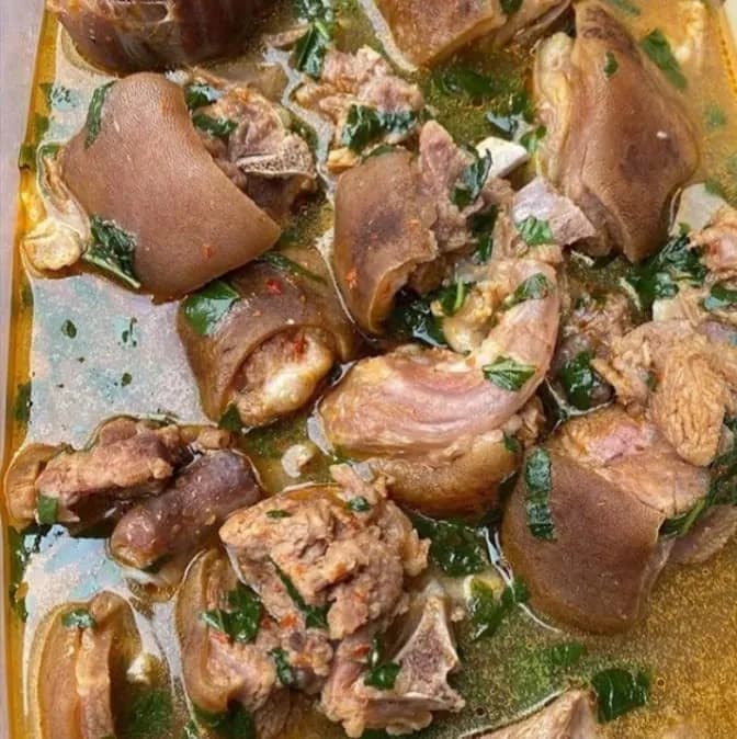 Goat meat pepper soup, a clear spiced Nigerian broth with tender goat and uziza leaves