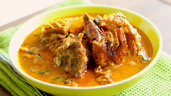Groundnut soup, a Nigerian peanut soup with assorted meat, smoked fish and palm oil