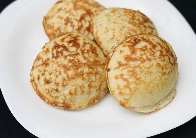 Hausa masa, fermented rice cakes from Northern Nigeria, served warm with honey
