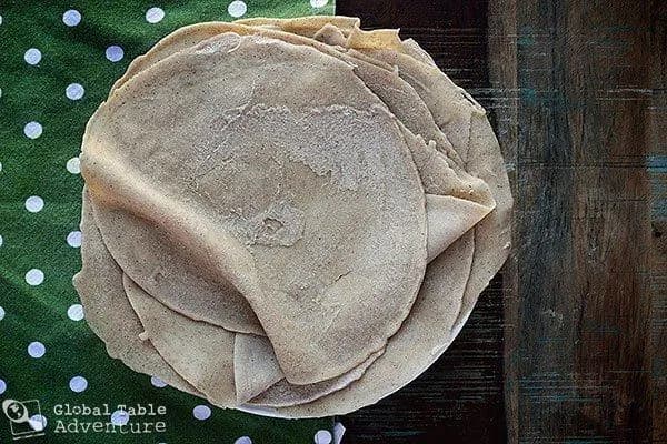 Kisra, thin fermented sorghum flatbread from Sudan stacked on a plate