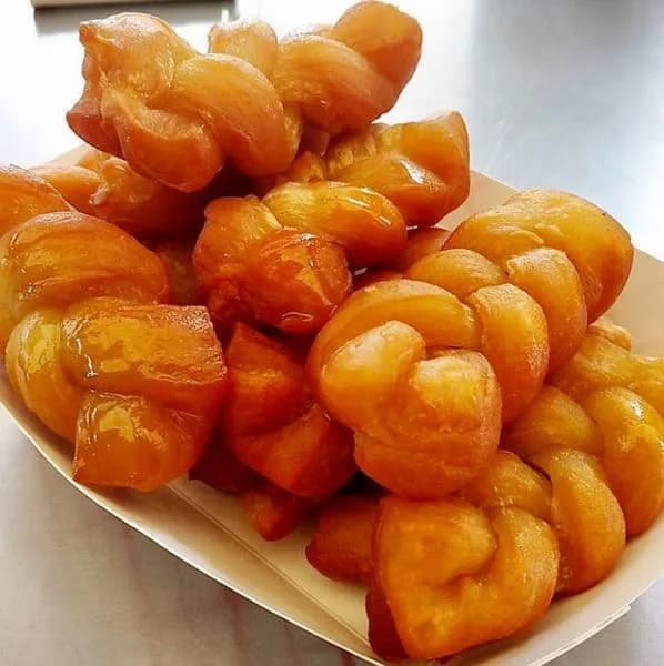 Koeksisters, plaited South African doughnuts soaked in cold syrup