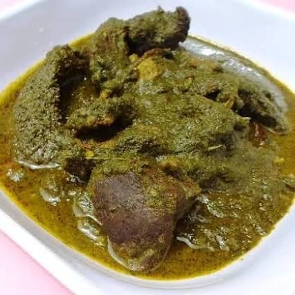 Marugbo soup, a dark Nigerian vegetable soup with goat meat and smoked fish