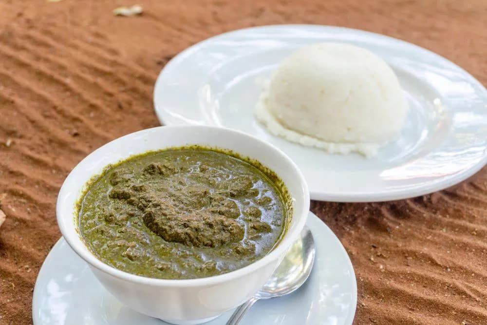 Matapa, a Mozambican dish of cassava leaves cooked with groundnuts, coconut milk and shrimp, served with rice