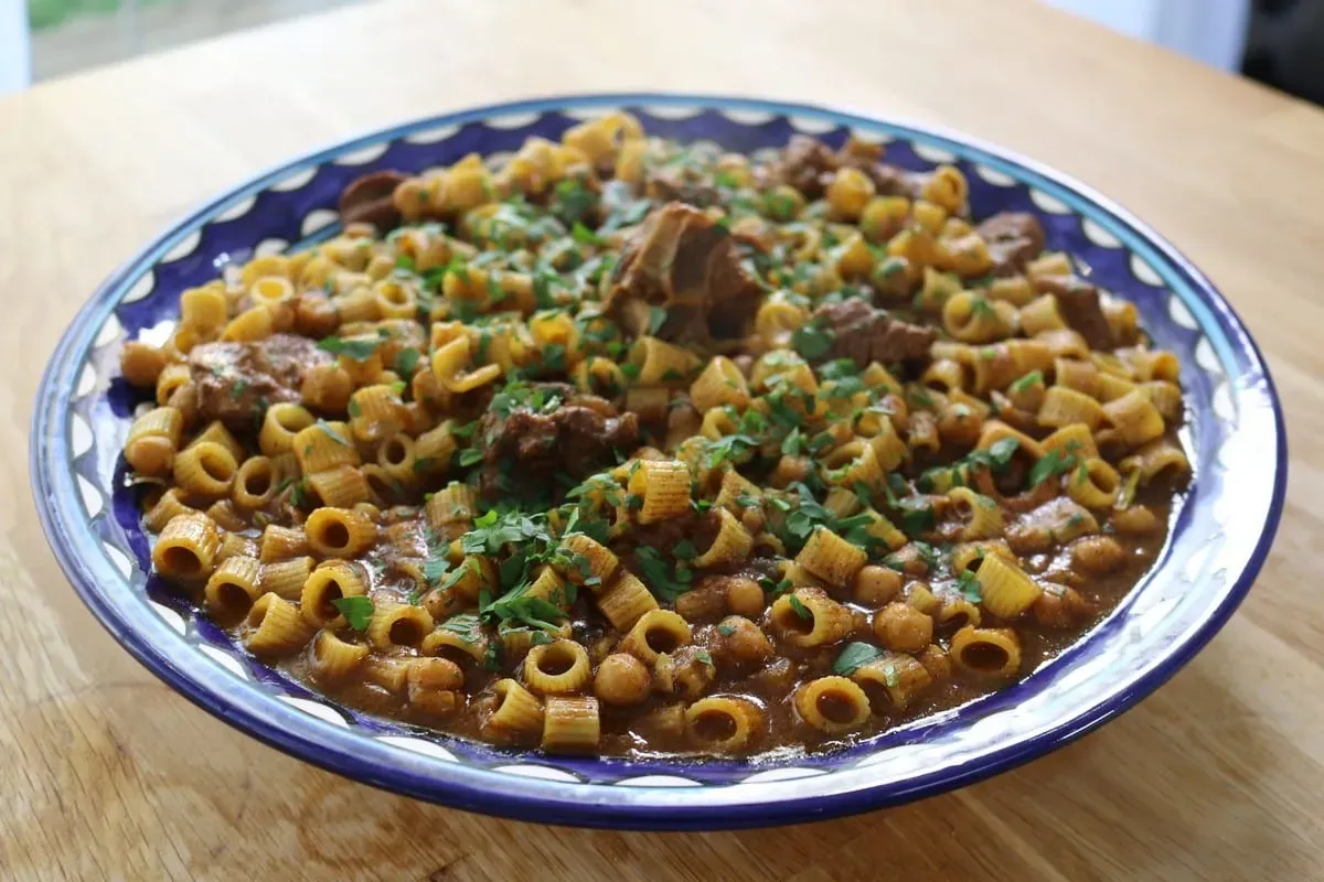 Mbakbaka, a Libyan one pot pasta stew with lamb, potatoes and North African spices