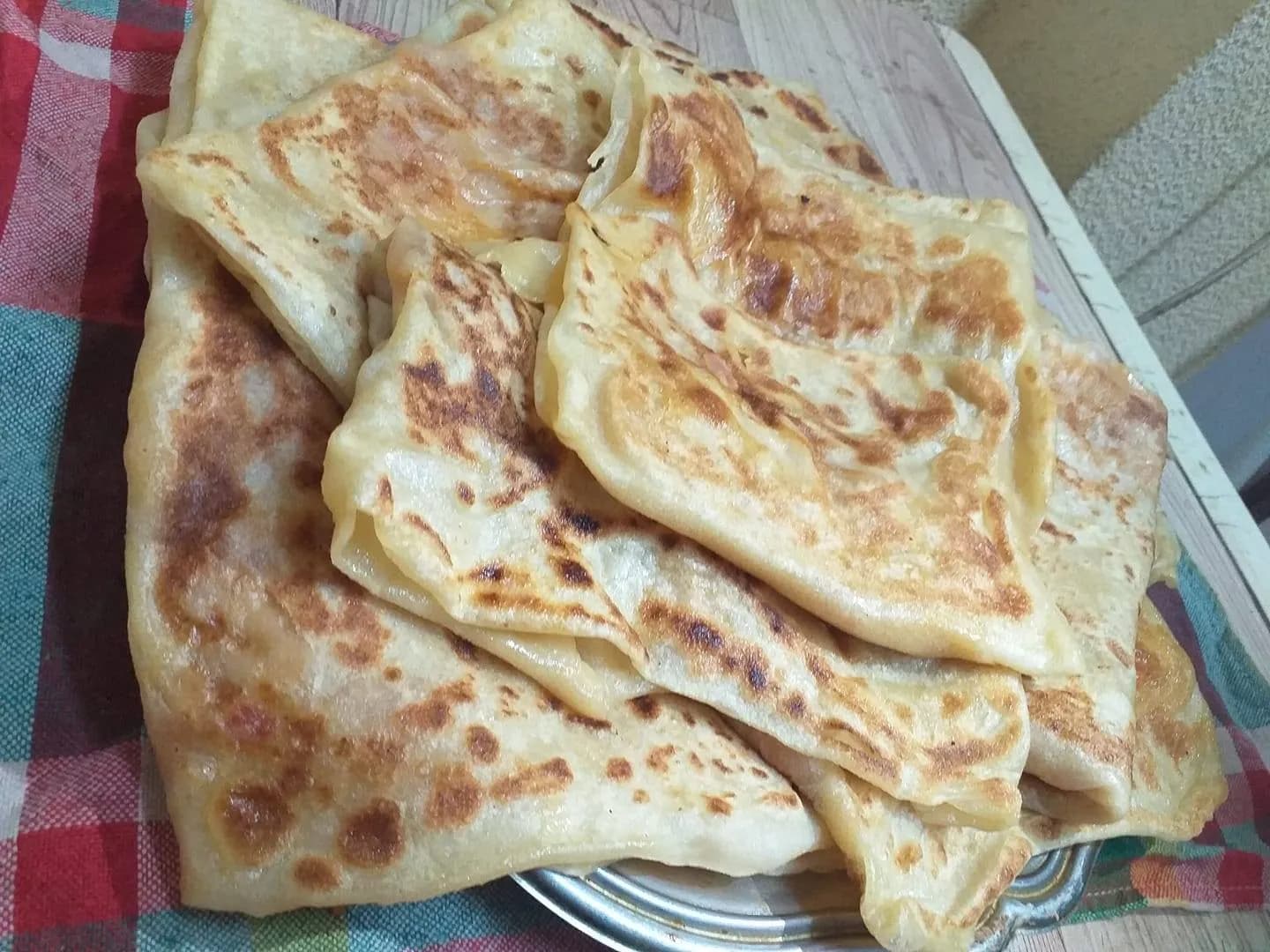 Mhajab, a North African stuffed flatbread folded into layers and cooked on a griddle