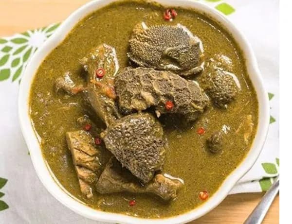 Miyan kuka, a Northern Nigerian baobab leaf soup, dark green and thick, served with tuwon shinkafa