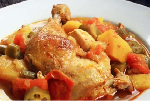 Muamba chicken, an Angolan chicken stew cooked in palm oil with peanut and okra, served over rice