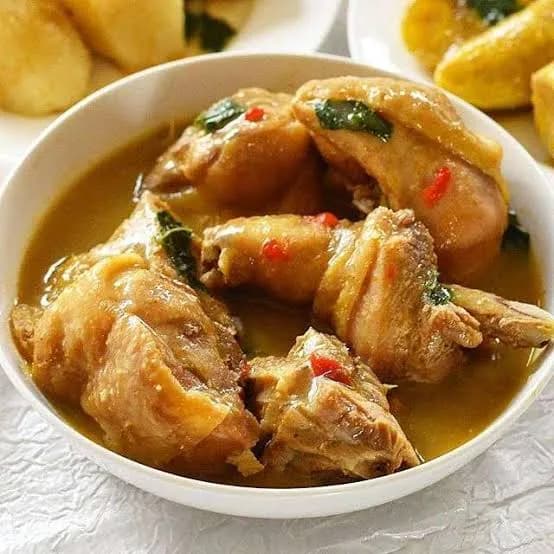 Nigerian chicken pepper soup, a clear spiced broth with chicken and scent leaves