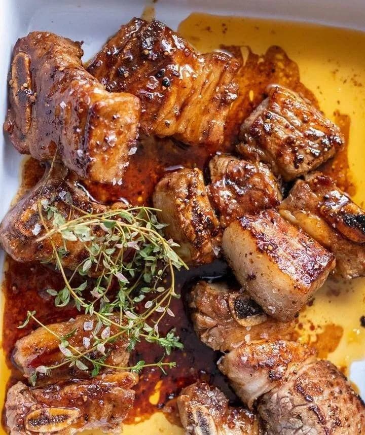 Nyama choma, Kenyan charcoal grilled goat meat, served with ugali and kachumbari