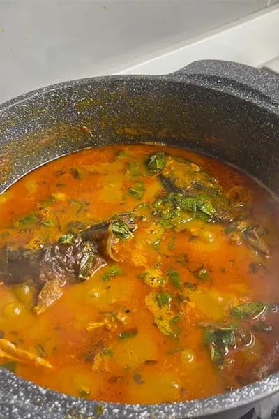 Ofe akwu, the Igbo palm nut soup with goat meat, ponmo and scent leaf