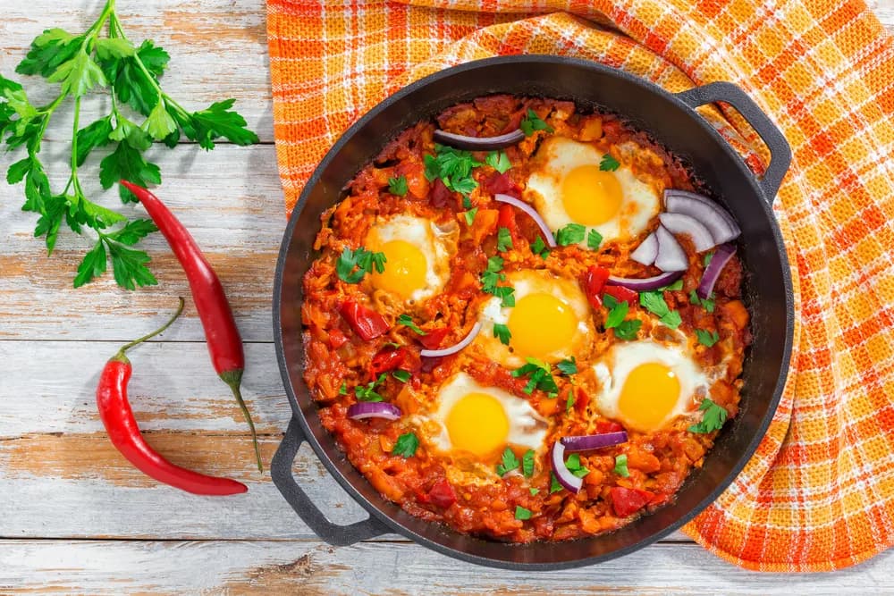 Ojja, Tunisian eggs poached in a spiced tomato, pepper and merguez sauce