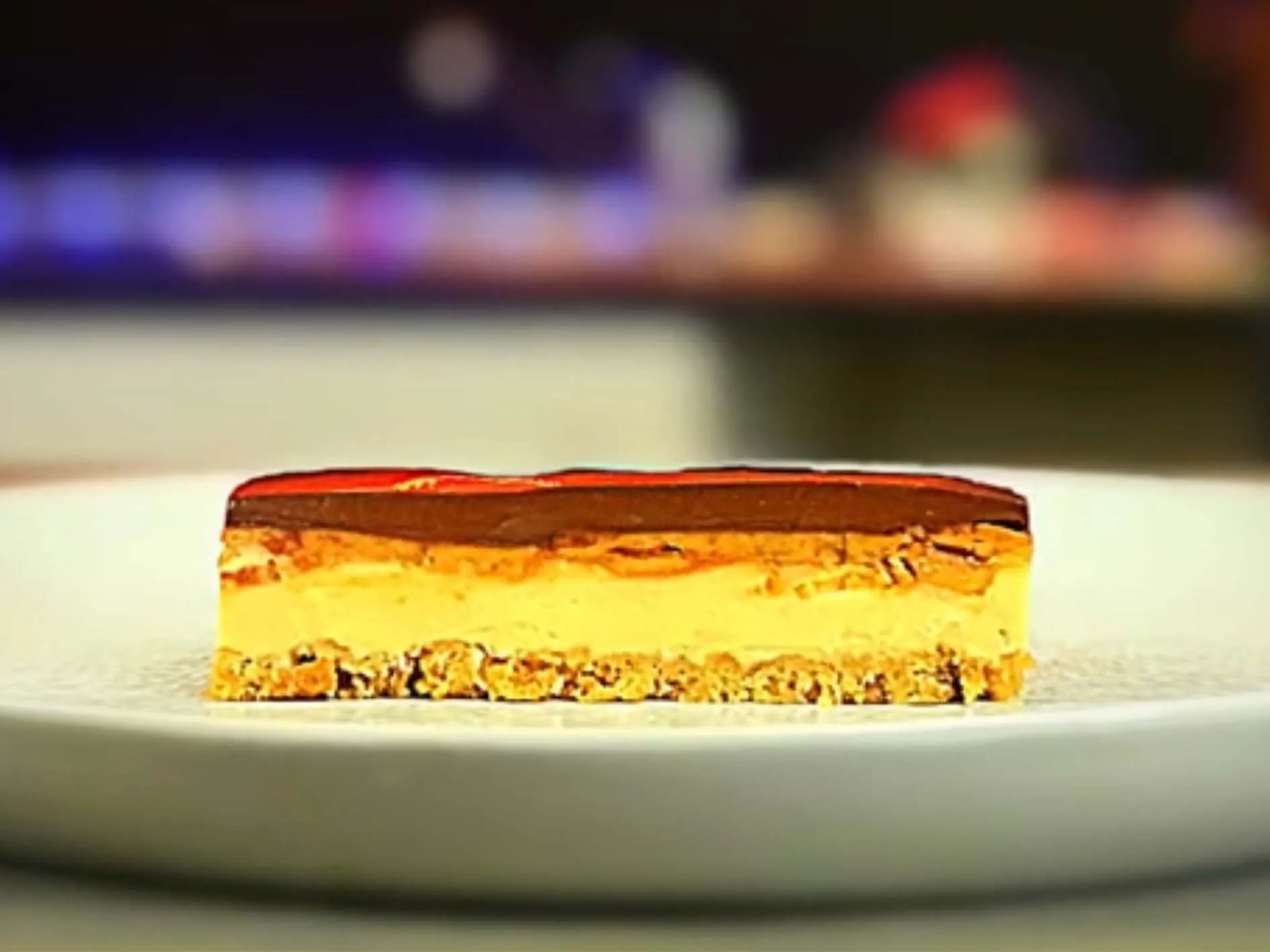 Peanut butter cheesecake with a biscuit base, fudge layer and chocolate ganache
