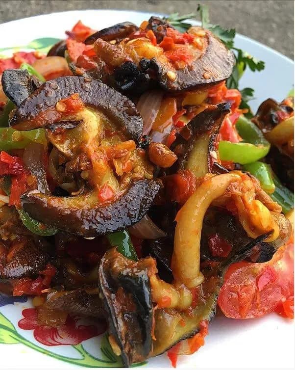 Peppered snail, a spicy Nigerian finger food of African giant snails in a scotch bonnet pepper sauce