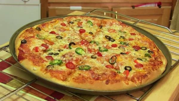 A homemade pizza with cheese and toppings, baked golden
